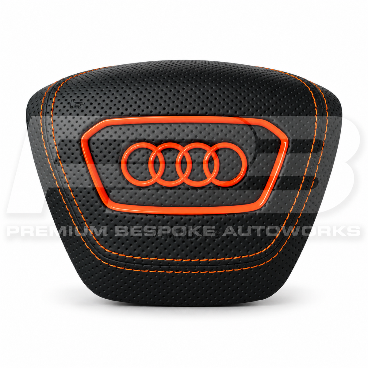 Audi RS7 4K custom airbag cover in black perforated leather with orange stitching and orange ring, front view, replaces the original plastic cover