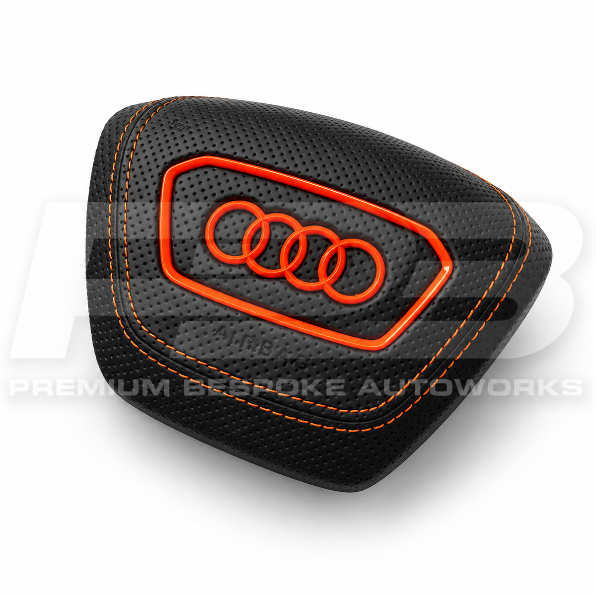 Audi RS7 4K custom airbag cover in black perforated leather with orange stitching, angled view showing the fit over the original airbag unit