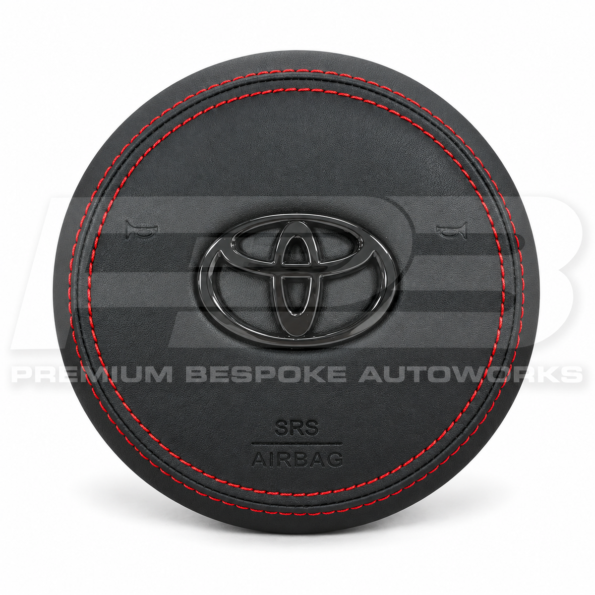 Toyota GR Supra A90 custom airbag cover in black leather with red contrast stitching and black badge, front view, replaces the original plastic cover