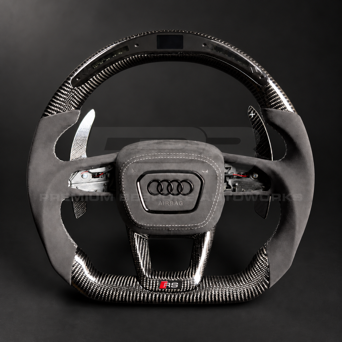 Audi RSQ8 custom steering wheel front view showing flat top and bottom, gloss carbon fibre, RPM race display, grey Alcantara grips and airbag cover, carbon paddles