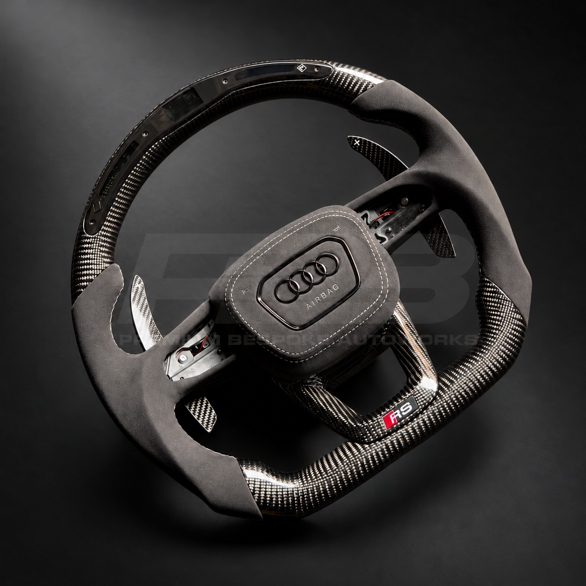 Audi RSQ8 custom steering wheel left angle showing flat top and bottom, gloss carbon fibre, RPM race display, grey Alcantara grips and airbag cover, carbon paddles