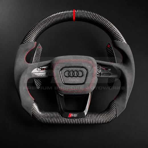 Audi RS3 8Y custom steering wheel front view, flat bottom, gloss carbon fibre top and bottom, red 12 o'clock marker, black Alcantara grips and airbag cover with red stitching