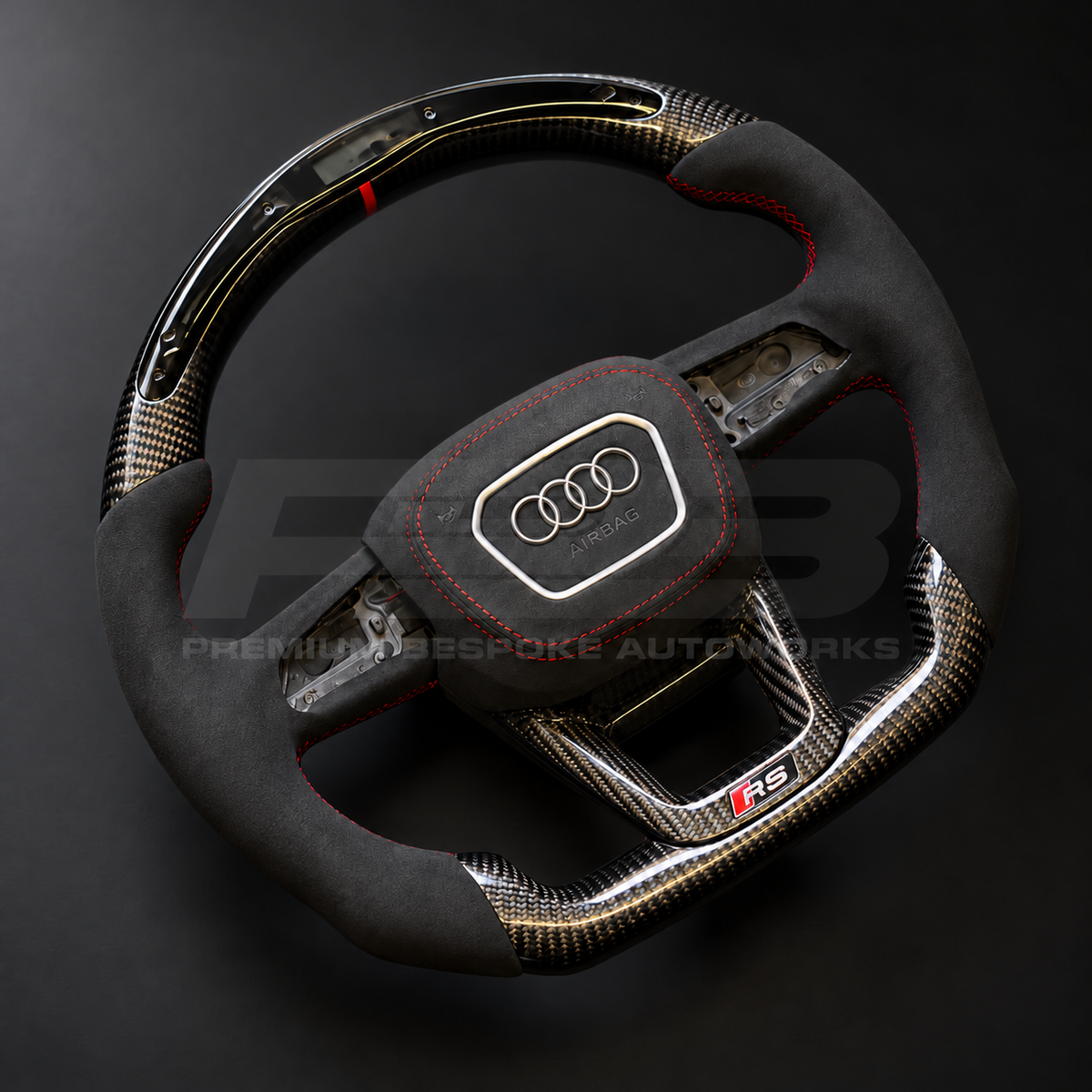Audi RS4 B9.5 custom steering wheel rotated to show the black Alcantara grips, red stitching and gloss carbon fibre top with LED race display