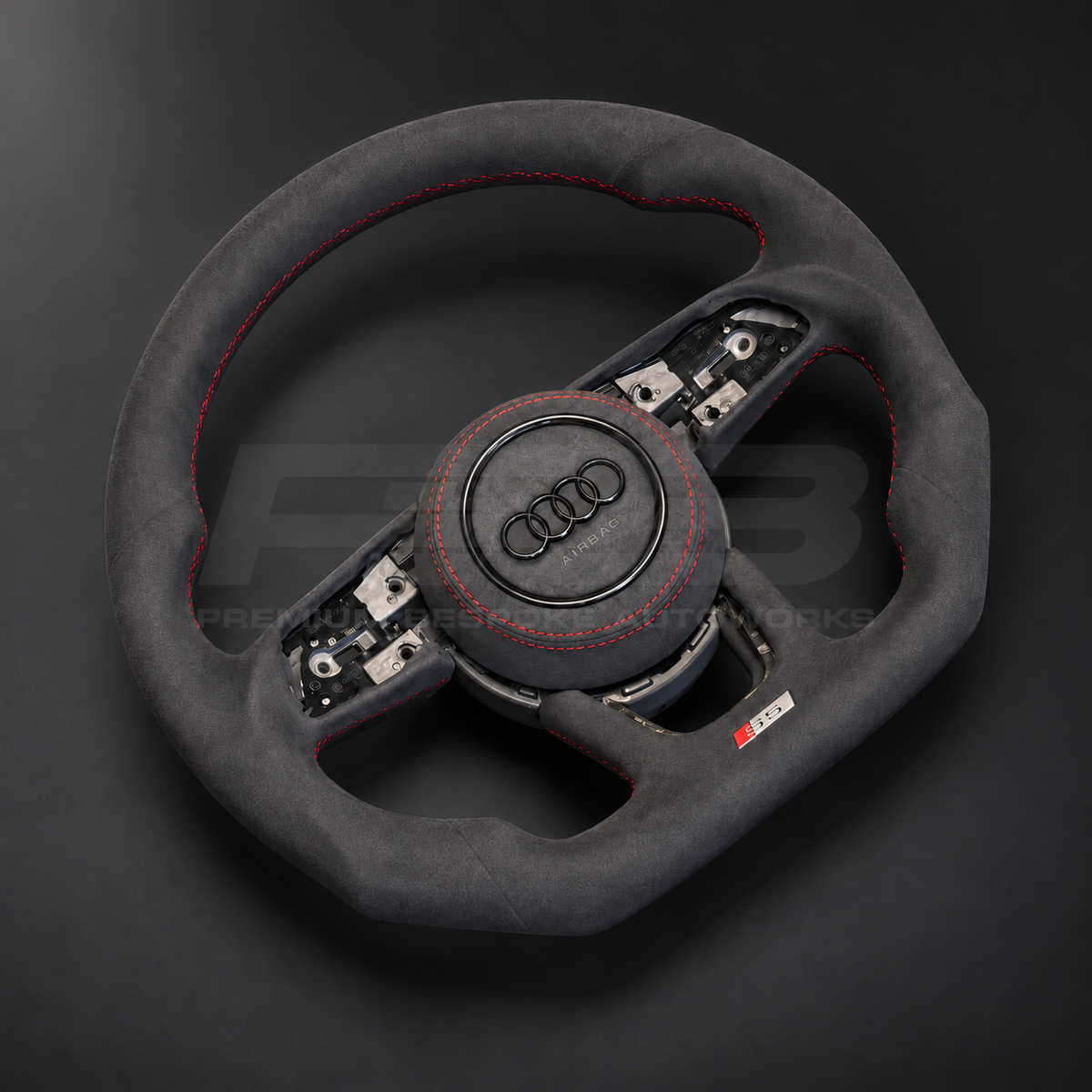Audi S5 B9 custom steering wheel left angle showing flat bottom, black Alcantara throughout, red stitching and Alcantara airbag cover
