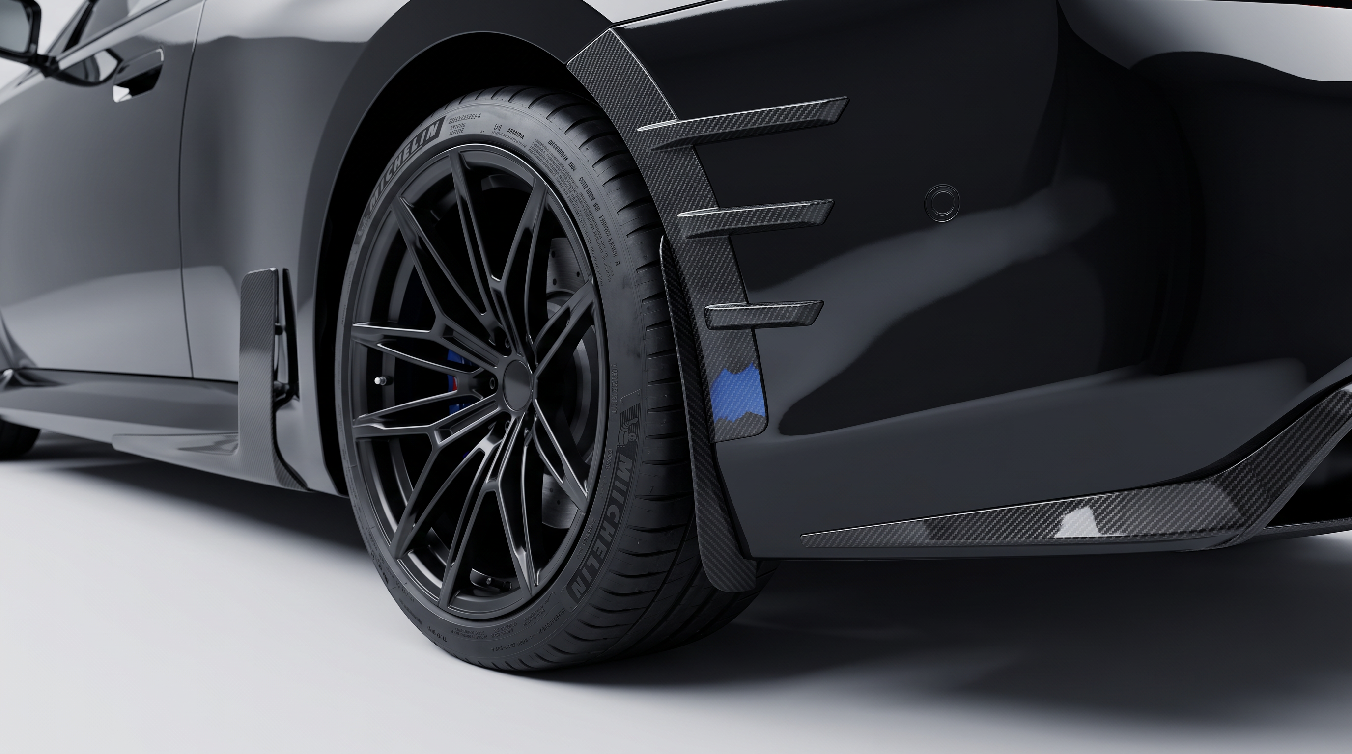 BMW M2 G87 carbon fibre wheel arch guard fitted to a gloss black M2 - Premium Bespoke AutoWorks