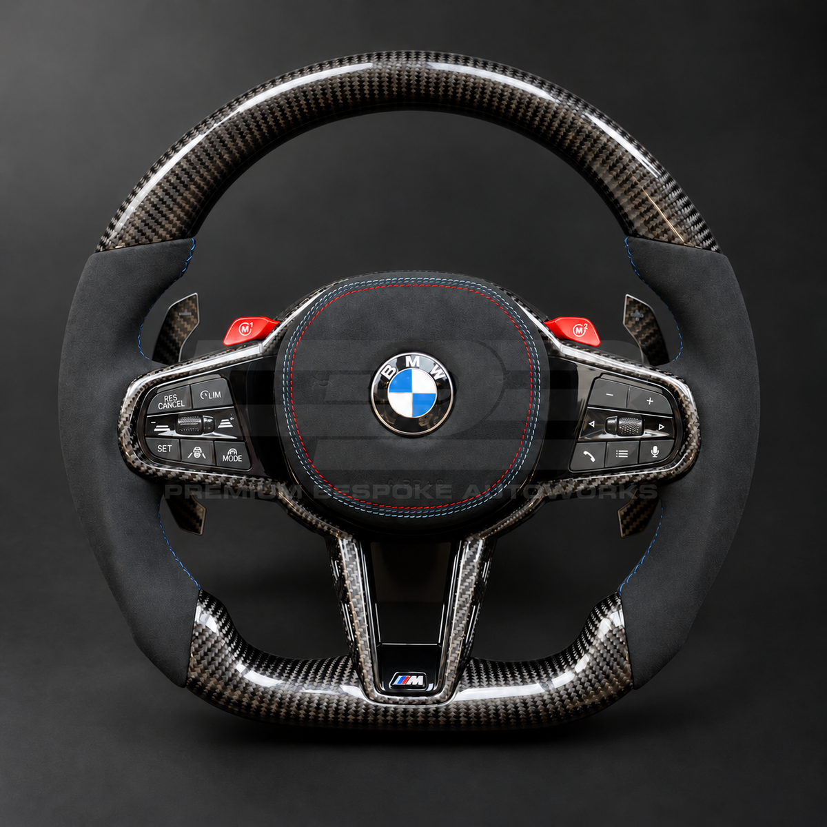 BMW M3 G80 LCI custom steering wheel front view, flat bottom, gloss carbon fibre top, bottom and trims, black Alcantara grips and airbag cover with M tricolour stitching, red M buttons