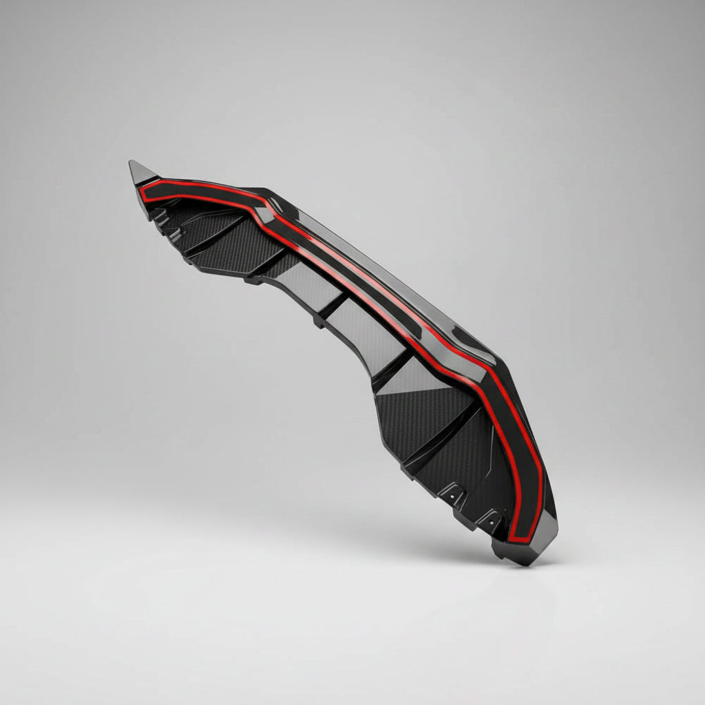 A carbon fiber rear diffuser with red pre installed tape, shown on a white background