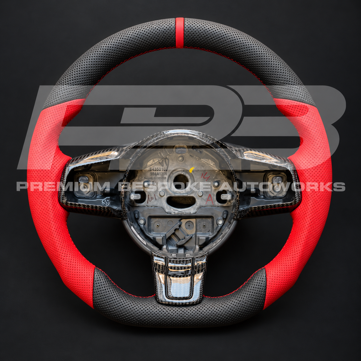 Jaguar F-Type custom steering wheel as built, flat bottom, perforated black leather with red leather grips, red stitching and 12 o'clock marker, carbon fibre spoke trims