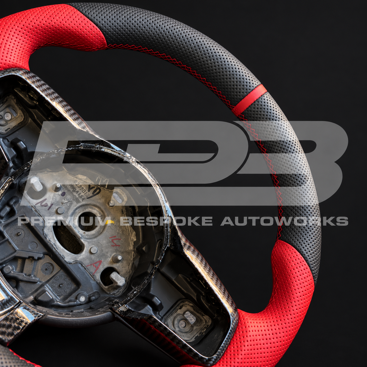 Red 12 o'clock marker, red stitching and perforated leather detail on a Jaguar F-Type custom steering wheel