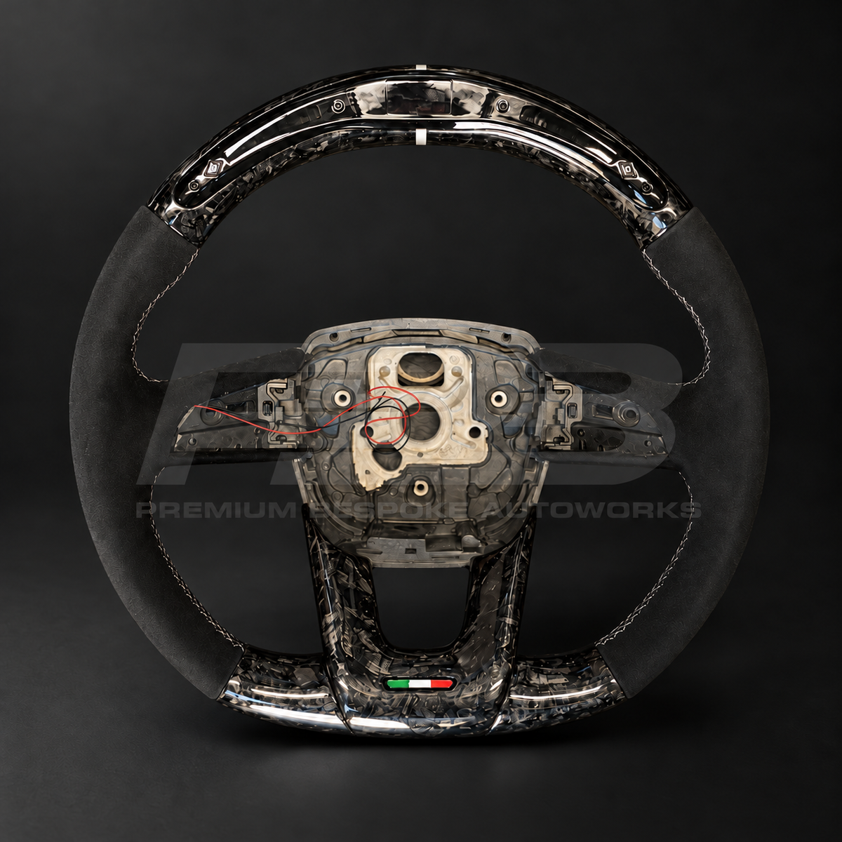 Lamborghini Urus custom steering wheel, front view, flat bottom gloss forged carbon fibre with LED race display, black Alcantara grips, silver stitching and forged carbon lower trim with Italian flag detail, customer build by Premium Bespoke AutoWorks