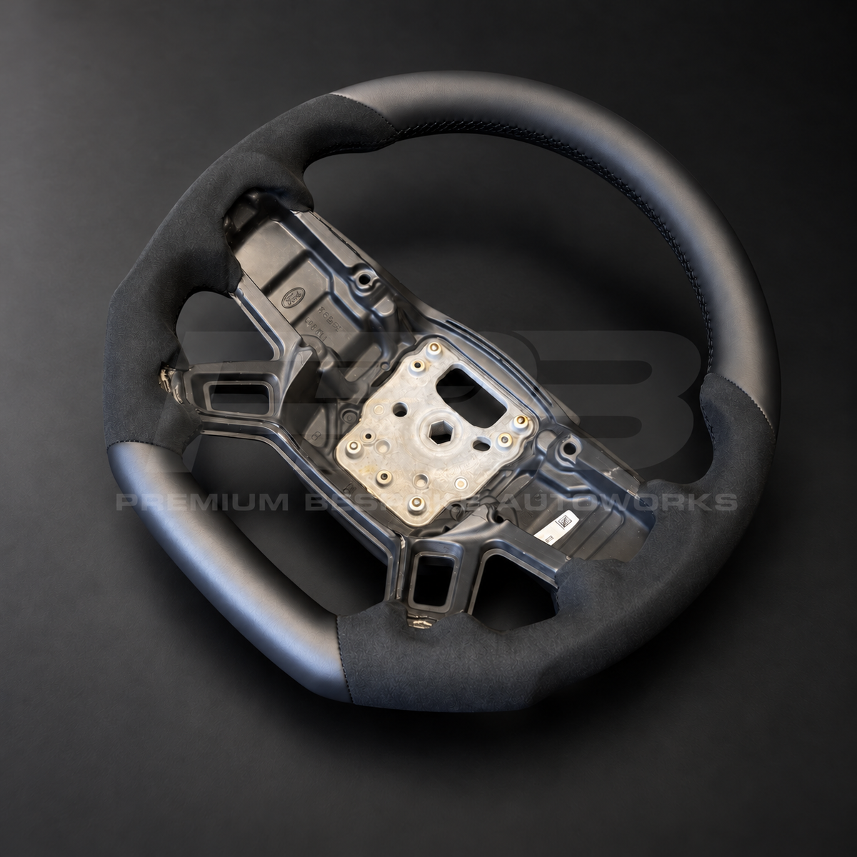 Land Rover Defender L663 custom steering wheel right angle showing flat bottom leather section and black Alcantara grip