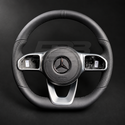 Mercedes-Benz CLS C257 custom steering wheel front view, flat bottom, smooth black leather, perforated grips, black stitching, leather airbag cover, factory silver spokes