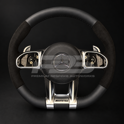 Mercedes-AMG GLE V167 custom steering wheel, front view, flat bottom with smooth black leather top and bottom, black Alcantara grips, black stitching and factory silver AMG trims, built by Premium Bespoke AutoWorks