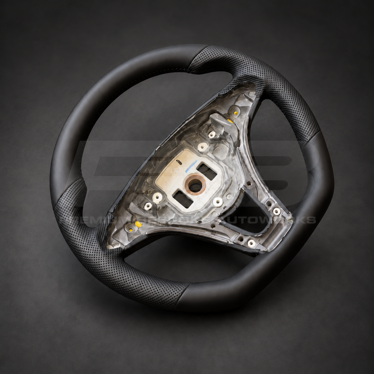 Mercedes X-Class custom steering wheel left angle showing flat bottom, smooth black leather and black perforated leather grips