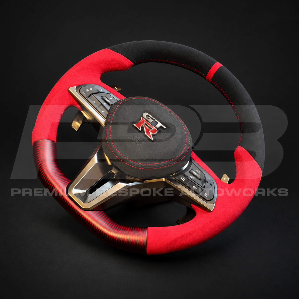 Nissan GT-R R35 EBA custom steering wheel from the opposite angle, red Alcantara grips, black Alcantara top and red carbon fibre bottom