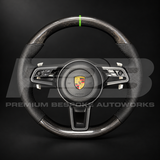 Porsche 911 991.2 custom steering wheel, front view: gloss carbon fibre top and bottom, perforated black leather grips, green 12 o'clock marker, gloss black trims and paddle shifters