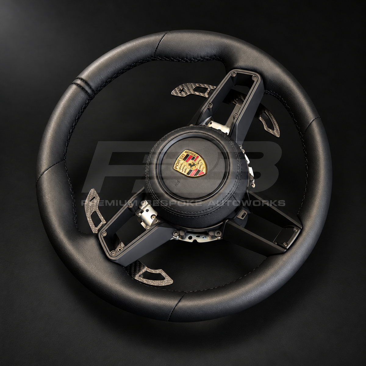 Porsche 911 992 custom steering wheel rotated to show the black nappa leather grips, stitched centre marker and magnetic carbon paddles
