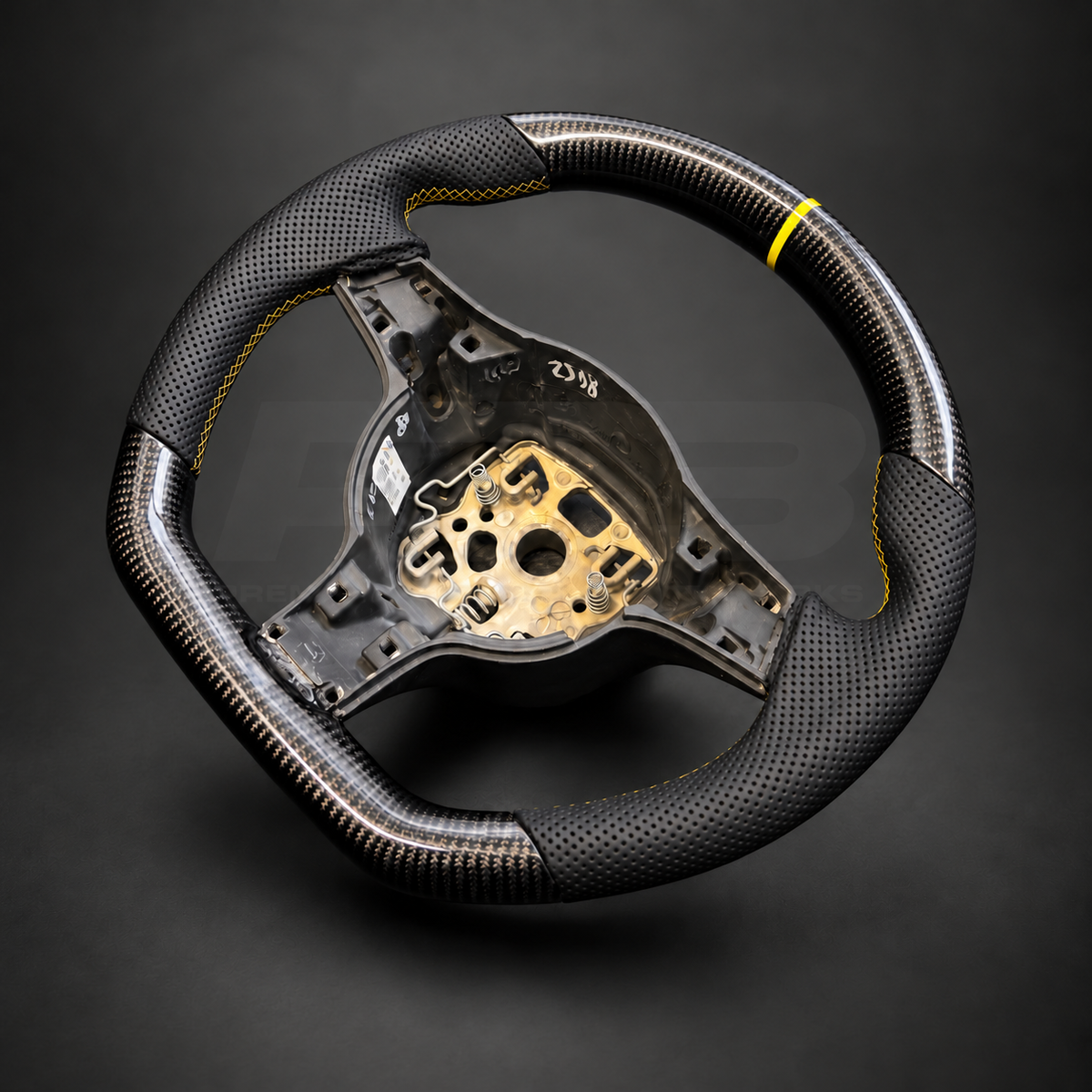 Porsche 911 997.2 custom steering wheel left angle showing flat top and bottom, gloss carbon fibre, black perforated leather grips, yellow stitching and yellow marker