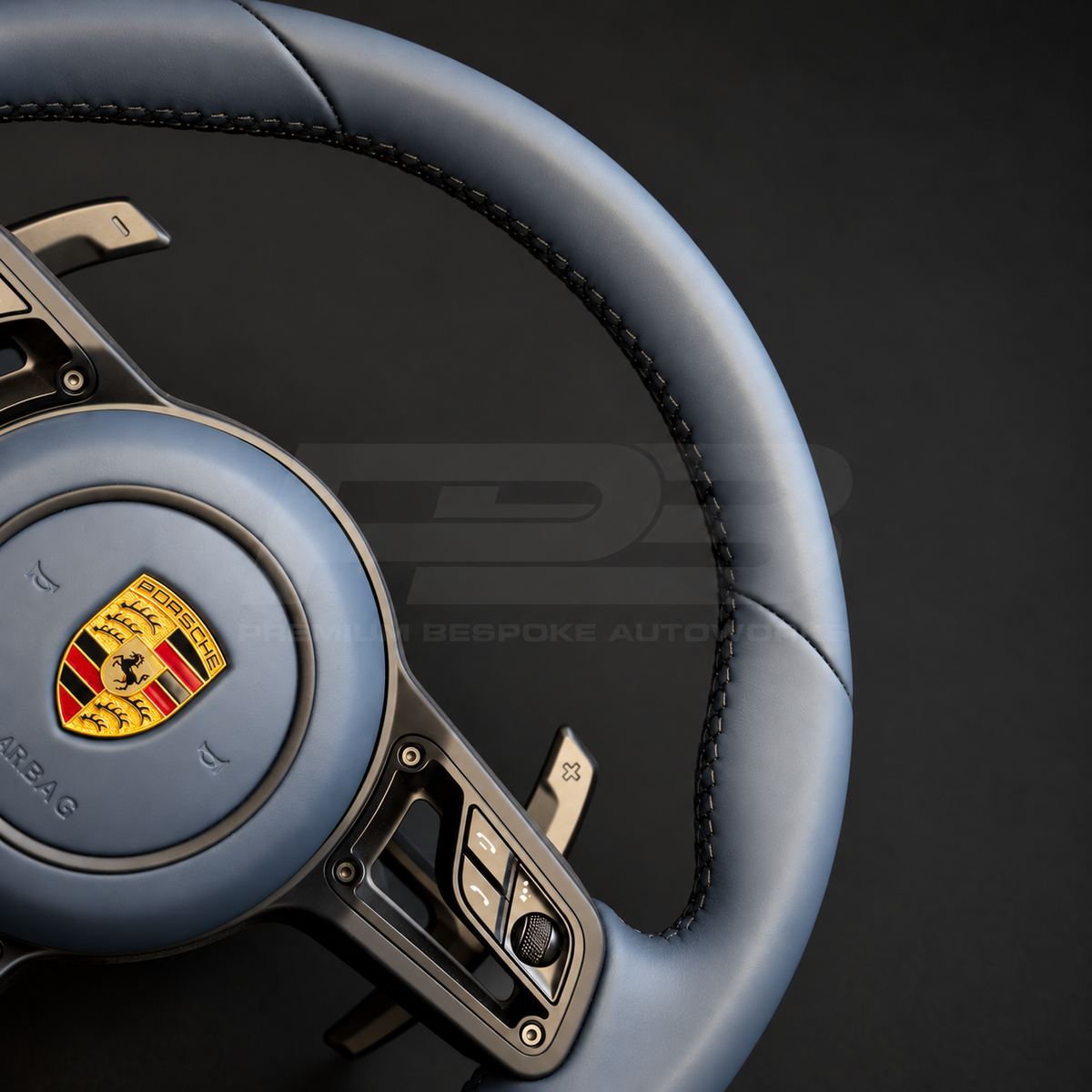 Porsche 911 997 steering wheel upgrade close up detail showing a 991.2 wheel in full blue leather with matching blue leather airbag cover and silver paddles