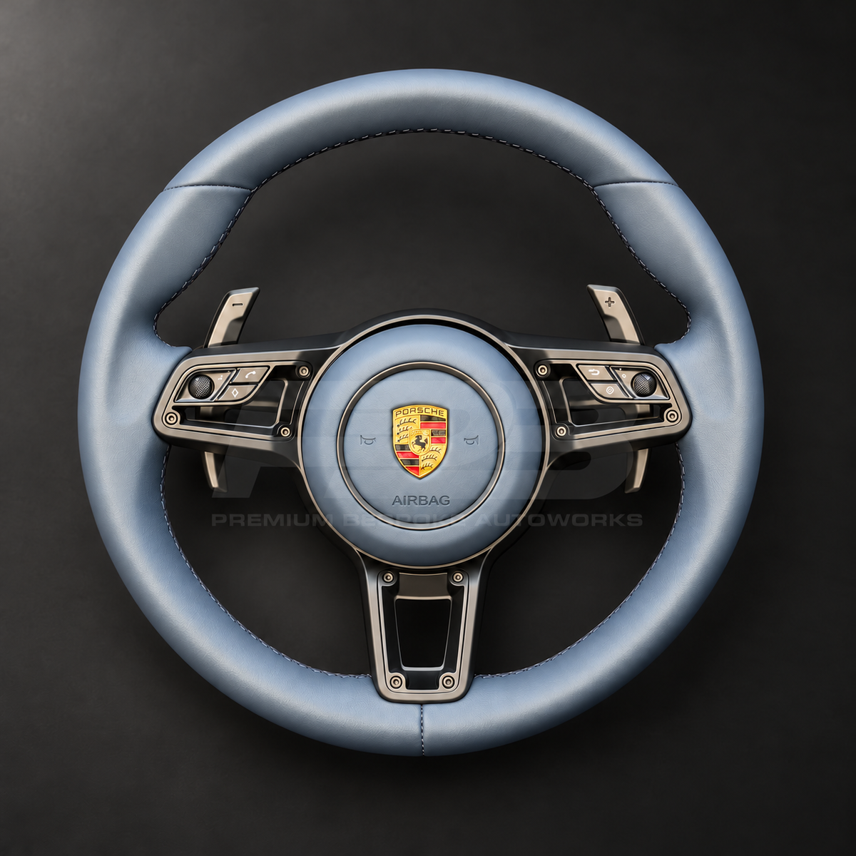 Porsche 911 997 steering wheel upgrade front view showing a 991.2 wheel in full blue leather with matching blue leather airbag cover and silver paddles