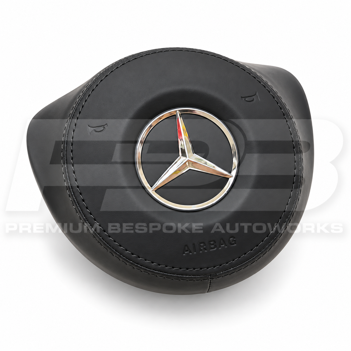 Mercedes A45 AMG W176 custom airbag cover in black leather, angled view showing the fit over the original airbag unit
