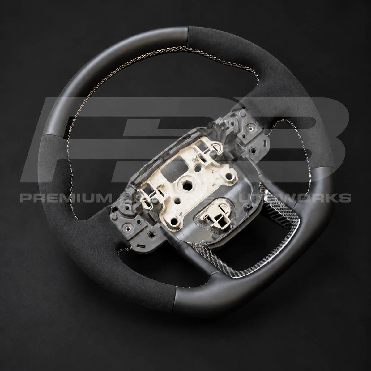 Range Rover Velar L560 custom steering wheel from above, Alcantara and leather with grey diamond stitching and carbon fibre lower spoke trims