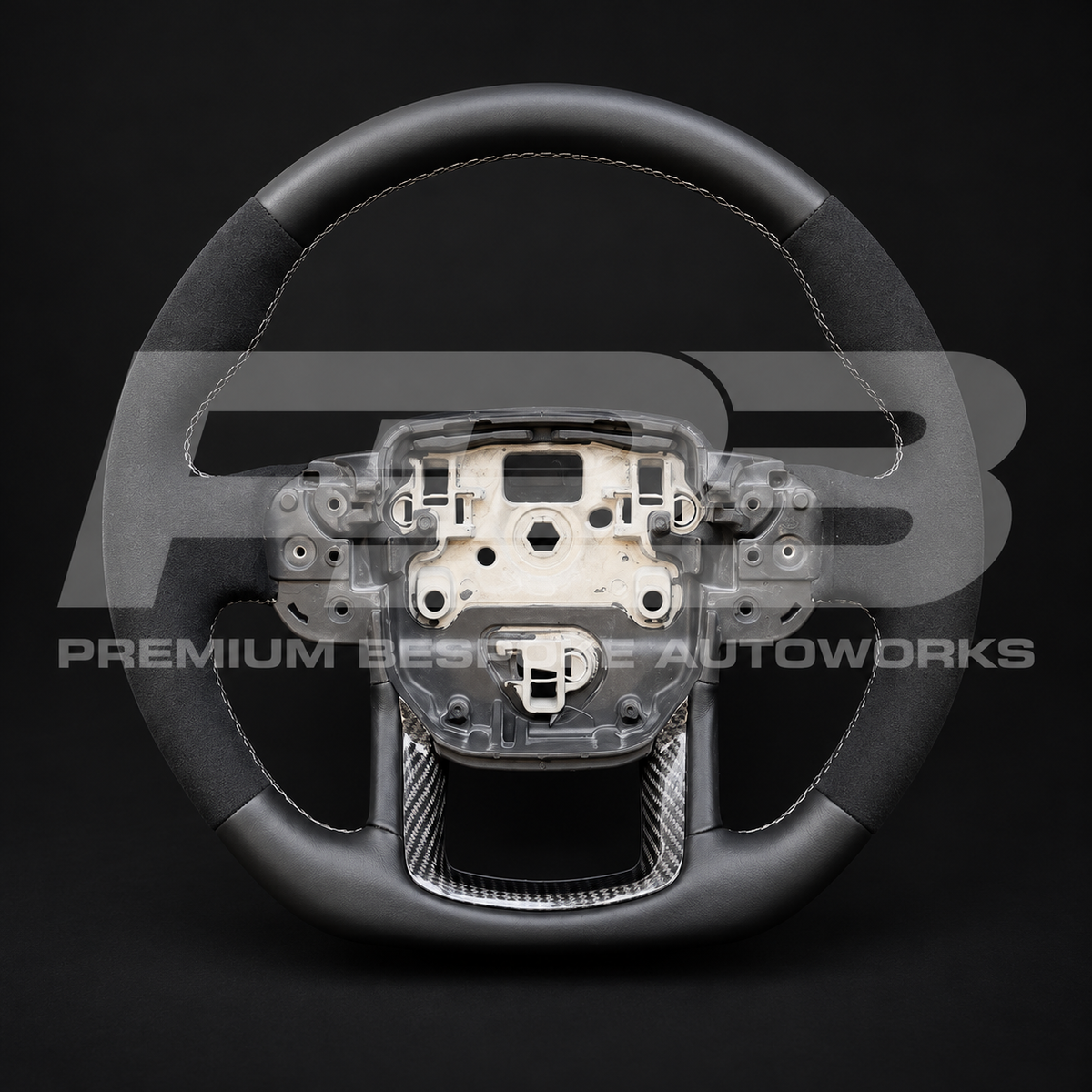 Range Rover Velar L560 custom steering wheel front facing shot, sports shape, black Alcantara grips, black leather, grey stitching, carbon fibre trims