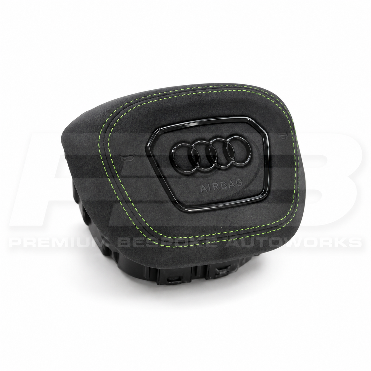 Audi RS3 8Y custom airbag cover in black Alcantara with green stitching, angled view showing the fit over the original airbag unit