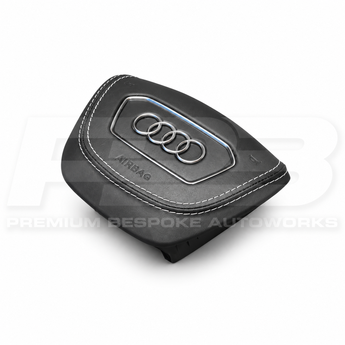 Audi RS6 C8 custom airbag cover in black leather with white stitching, angled view showing the fit over the original airbag unit