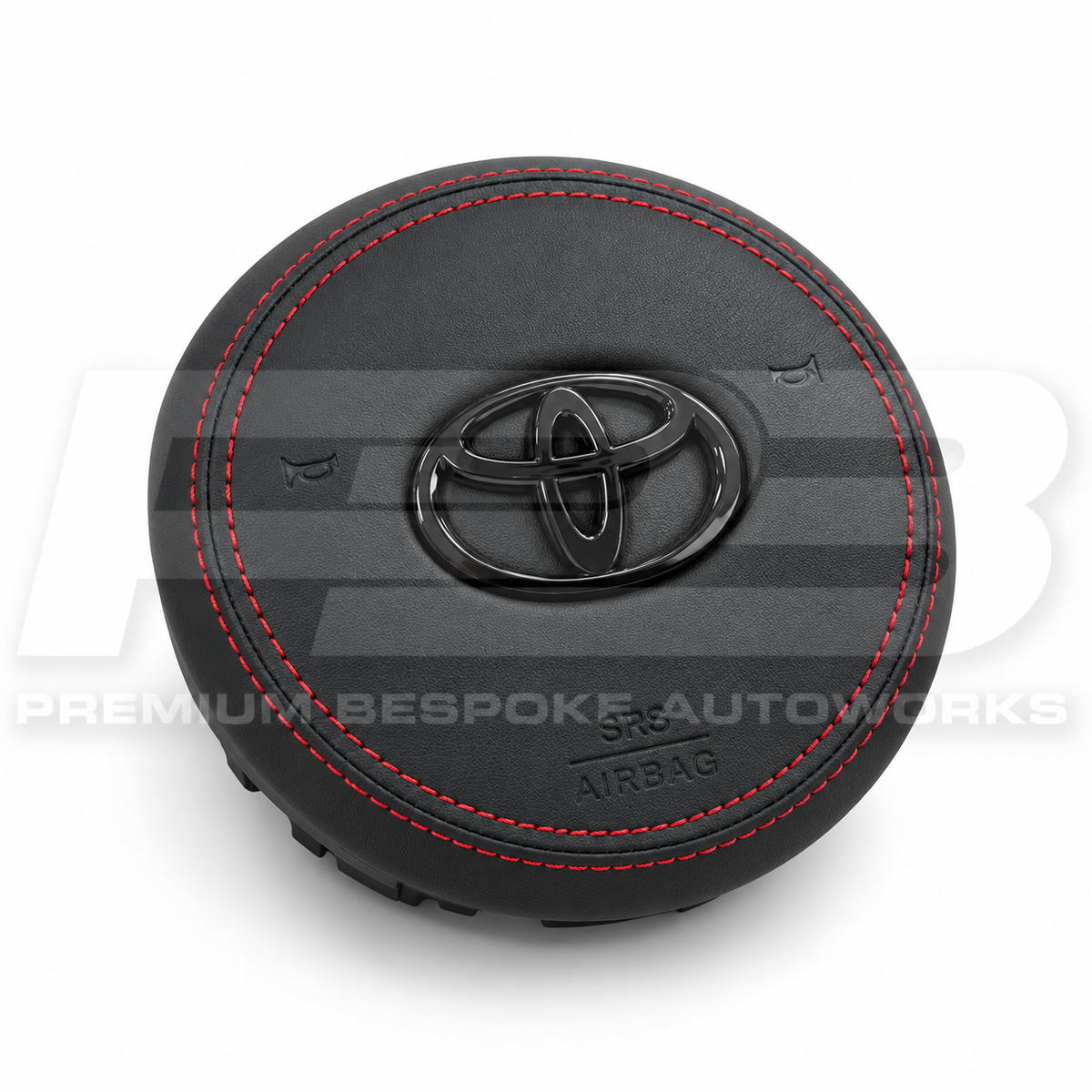 Toyota GR Supra A90 custom airbag cover in black leather with red stitching, angled view showing the fit over the original airbag unit