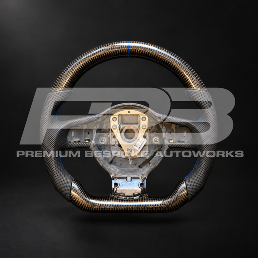 Audi R8 Gen 1 custom steering wheel, front view: flat bottom, gloss carbon fibre top and bottom, perforated black leather grips, navy blue stitching and 12 o'clock marker