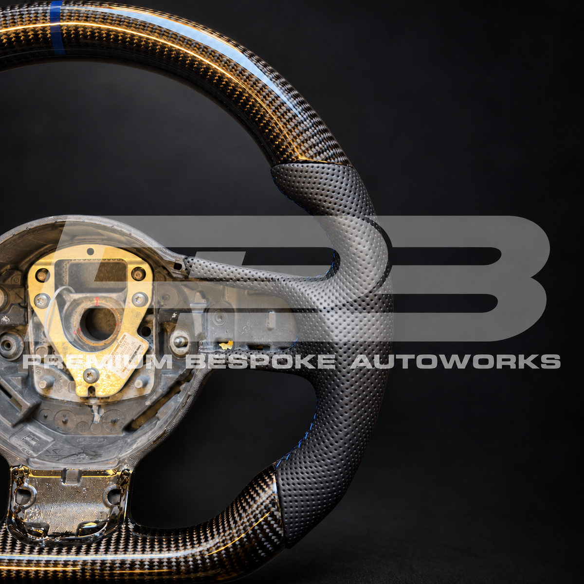 Audi R8 Gen 1 custom steering wheel from above, gloss carbon fibre top and bottom with perforated leather grips and navy blue stitching