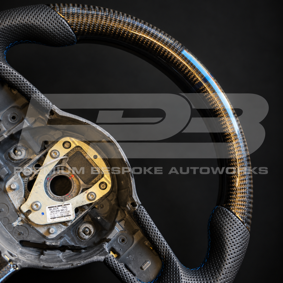 Close up of the gloss carbon fibre top section with navy blue 12 o'clock marker on an Audi R8 Gen 1 custom steering wheel