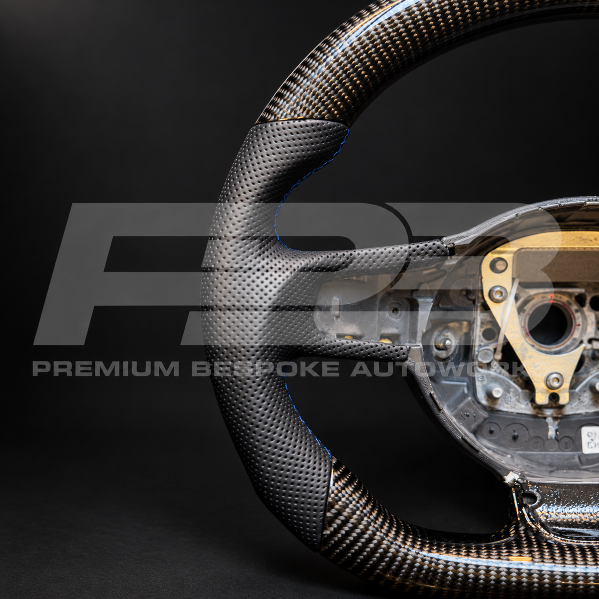 Close up of the perforated black leather grip with navy blue stitching on an Audi R8 Gen 1 custom steering wheel
