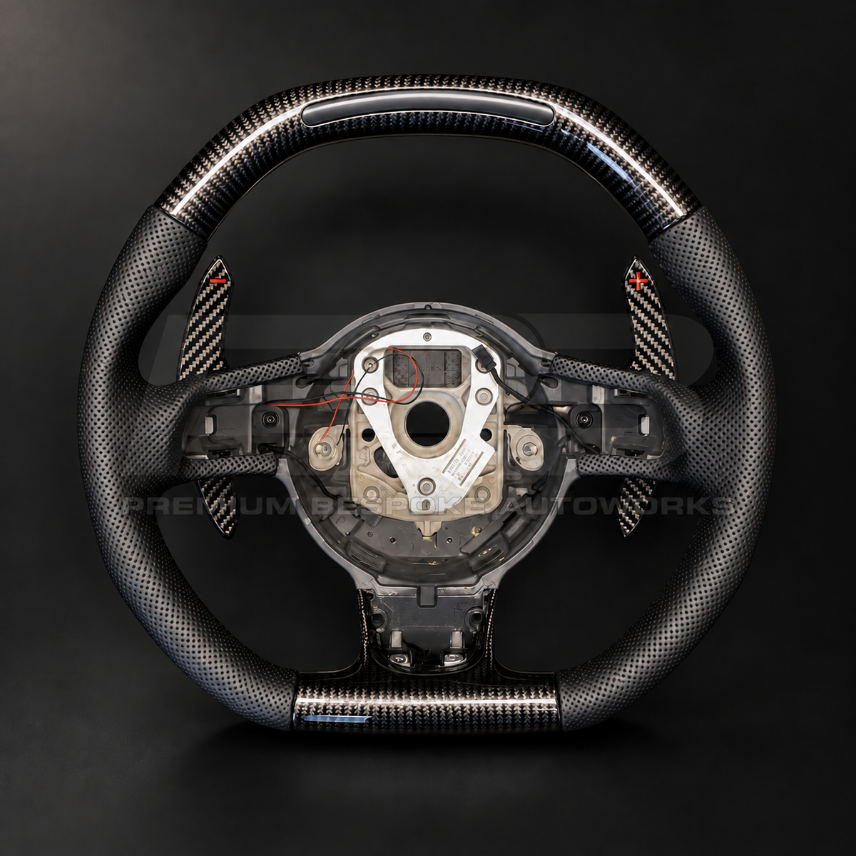Audi R8 Gen 1 custom steering wheel, front view, flat top and flat bottom gloss carbon fibre with RPM light bar, perforated black leather grips and carbon paddle shifters, customer build by Premium Bespoke AutoWorks