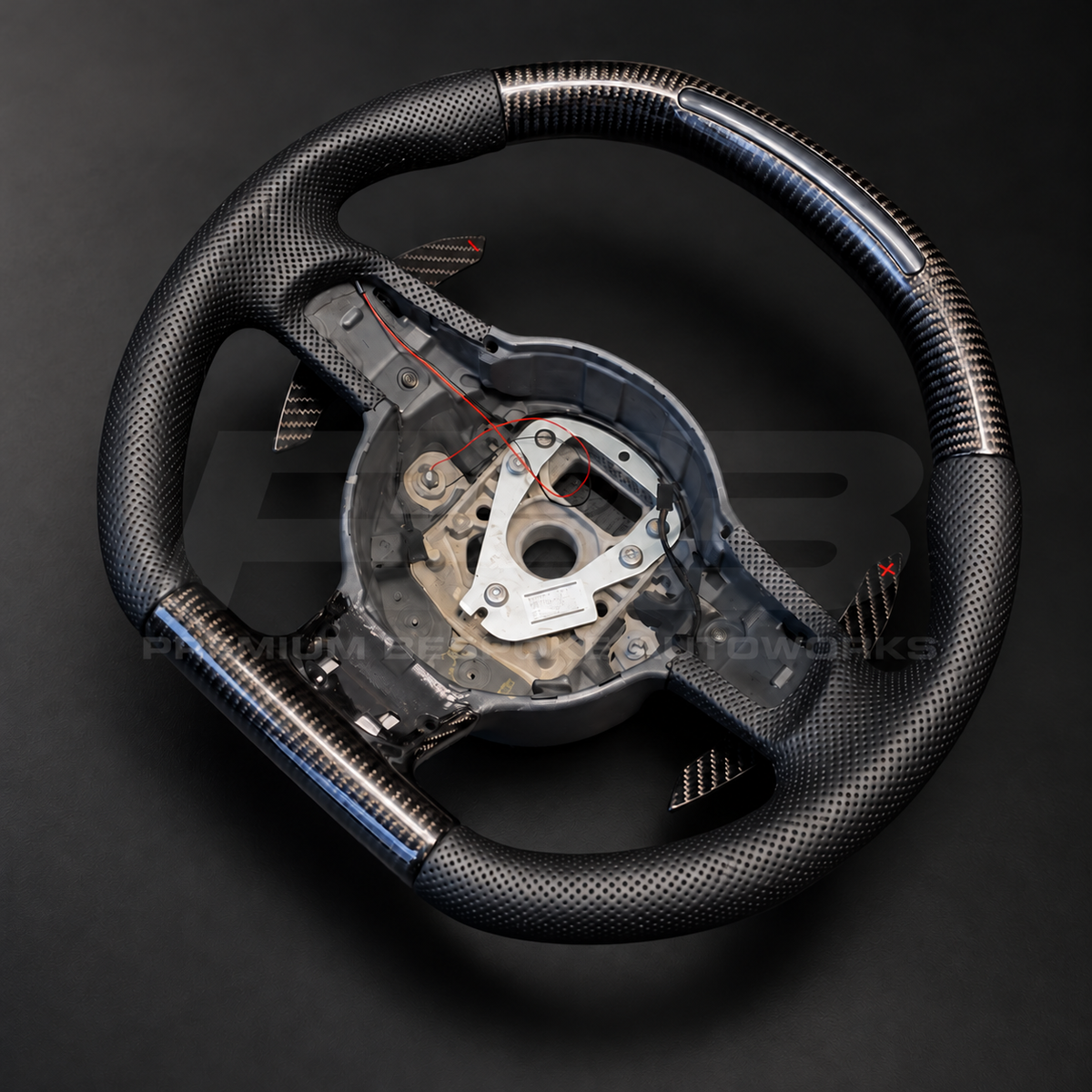 Audi R8 Gen 1 custom steering wheel rotated to show the flat carbon fibre bottom section and carbon paddle shifters