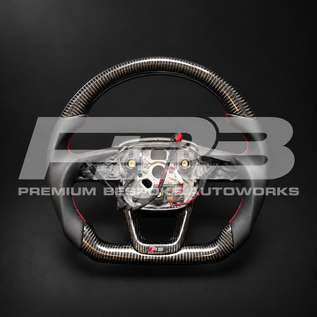 Audi RS Q8 custom steering wheel, front view: flat bottom, gloss carbon fibre top and bottom, smooth black leather grips with red stitching, carbon lower trim with RS badge