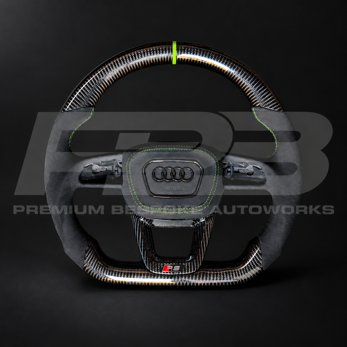 Audi RS3 8Y custom steering wheel, front view: flat bottom, gloss carbon fibre top and bottom, black Alcantara grips, Kyalami green stitching and 12 o'clock marker, Alcantara airbag cover and carbon RS trim