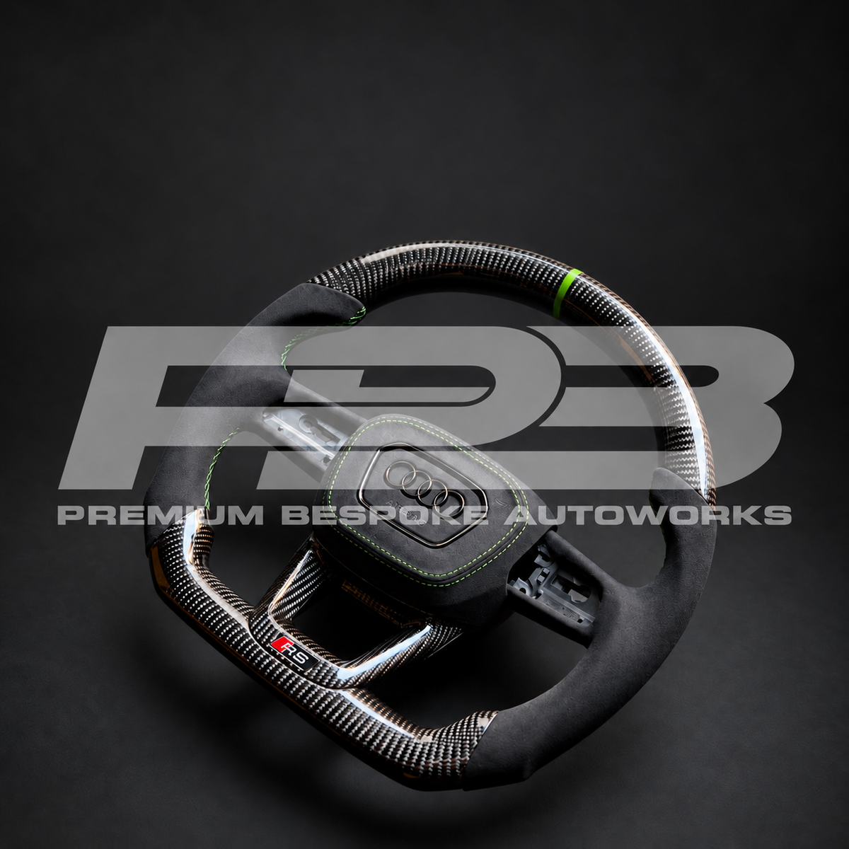 Audi RS3 8Y custom steering wheel angled from the left, carbon fibre and black Alcantara with Kyalami green stitching