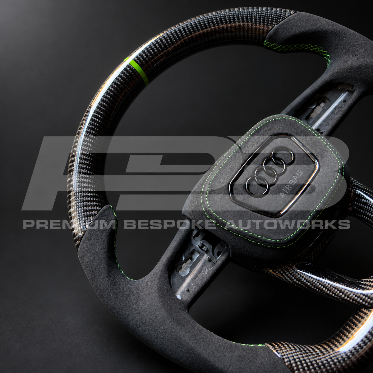 Close up of the black Alcantara grip with Kyalami green stitching and the green 12 o'clock marker on an Audi RS3 8Y custom steering wheel