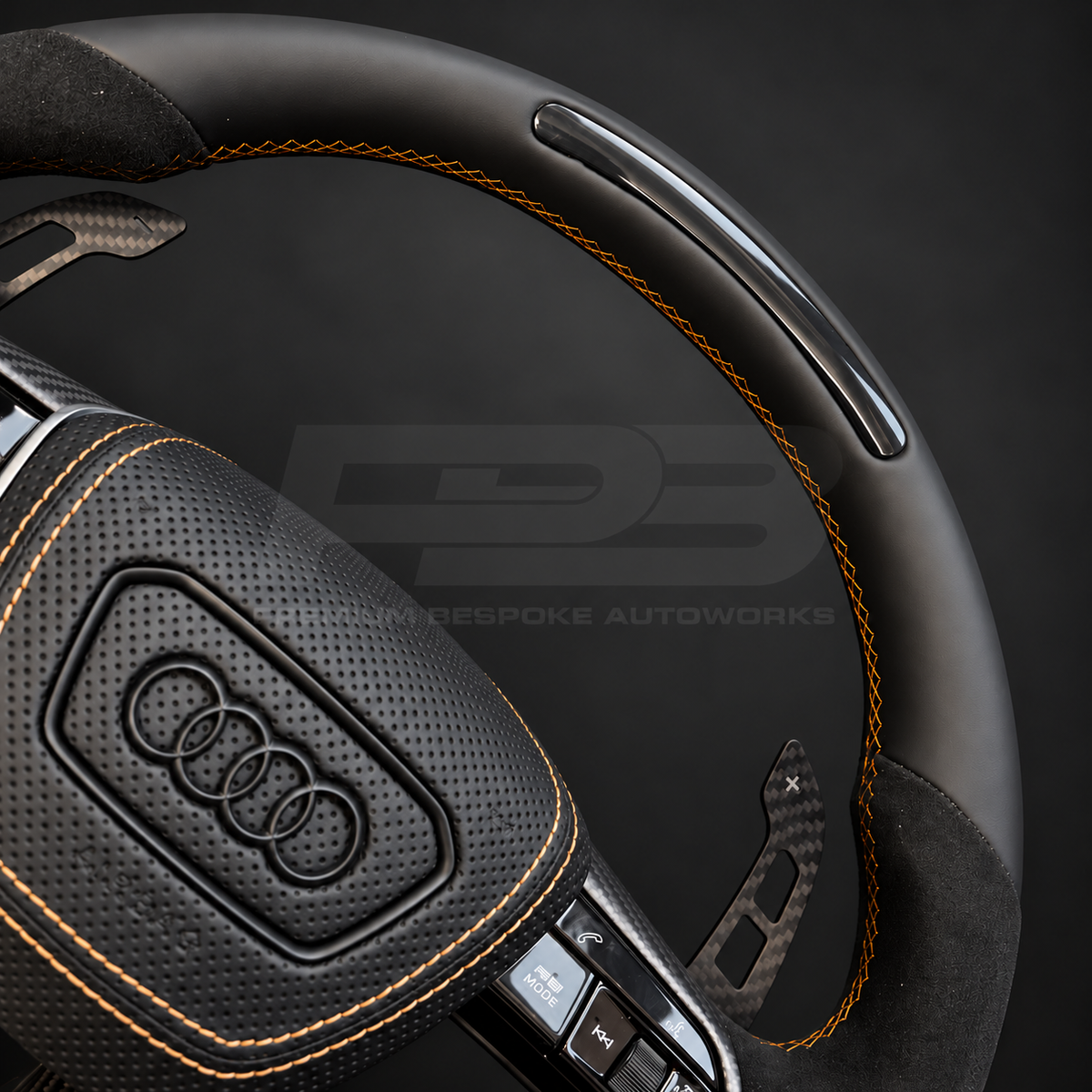 Audi RS7 4K8 custom steering wheel close up detail showing black Nappa leather top with RPM lights, matte carbon bottom, Alcantara grips and copper stitching