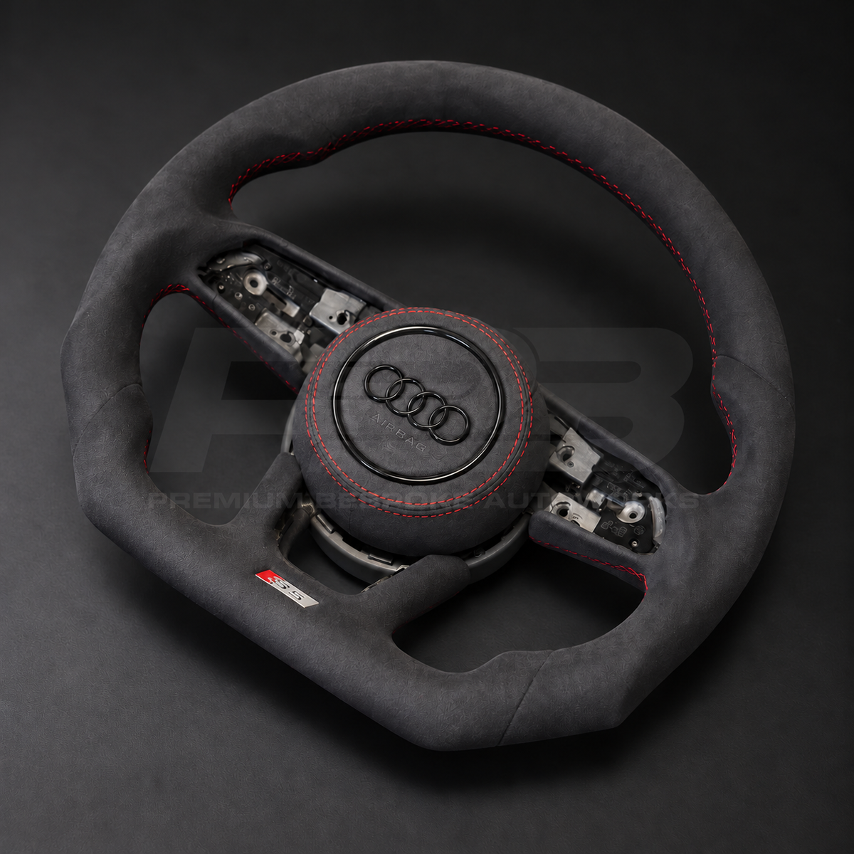 Audi S5 B9 custom steering wheel right angle showing flat bottom, black Alcantara throughout, red stitching and Alcantara airbag cover