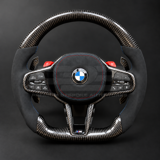 BMW M3 G80 LCI custom steering wheel front view, flat bottom, gloss carbon fibre top, bottom and trims, black Alcantara grips and airbag cover with M tricolour stitching, red M buttons