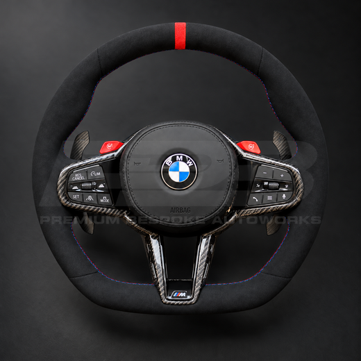 BMW M4 G82 LCI custom steering wheel front view, full black Alcantara, red 12 o'clock marker, M tricolour stitching, Alcantara airbag cover, carbon trims, red M buttons
