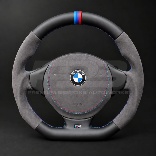 BMW Z3 custom steering wheel front view showing flat bottom, black leather top and bottom, dark grey Alcantara grips and airbag cover, M stitching and M stripe
