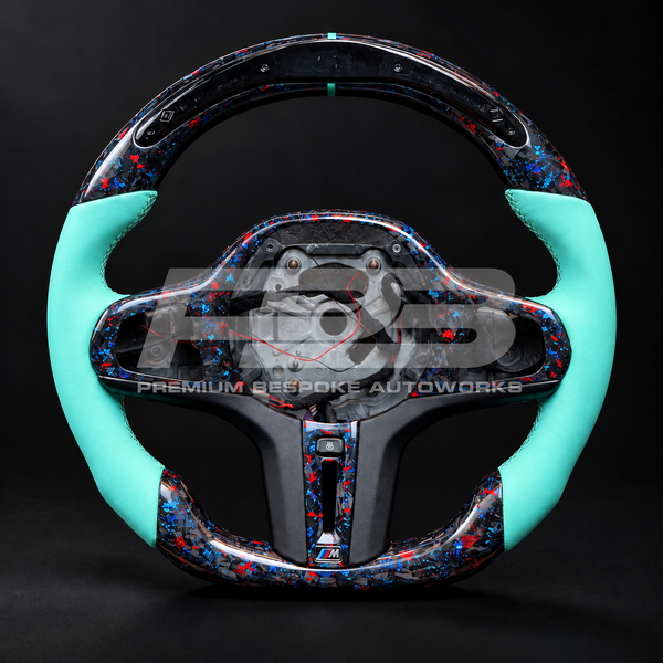 BMW Z4 G29 custom steering wheel, front view, flat bottom red and blue flecked forged carbon fibre with LED race display and Tiffany blue leather grips, customer build by Premium Bespoke AutoWorks