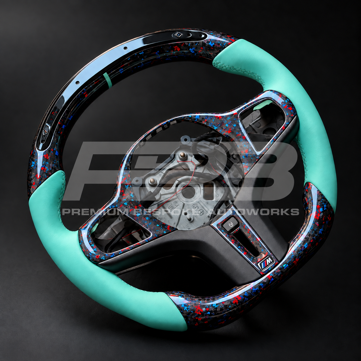 BMW Z4 G29 custom steering wheel rotated to show the Tiffany blue leather grips and stitching and the flecked forged carbon spoke trims