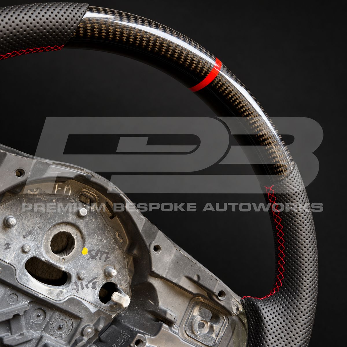Close up of the gloss carbon fibre top section with red 12 o'clock marker and red stitched perforated grip on a Jaguar F-Type custom steering wheel