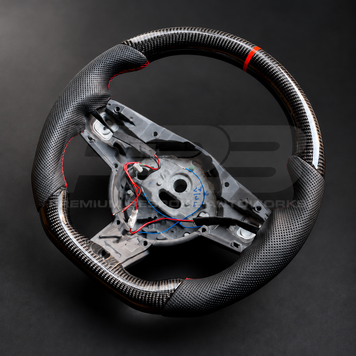 Jaguar F-Type custom steering wheel right angle showing flat bottom carbon section and heated wheel wiring on the OEM core