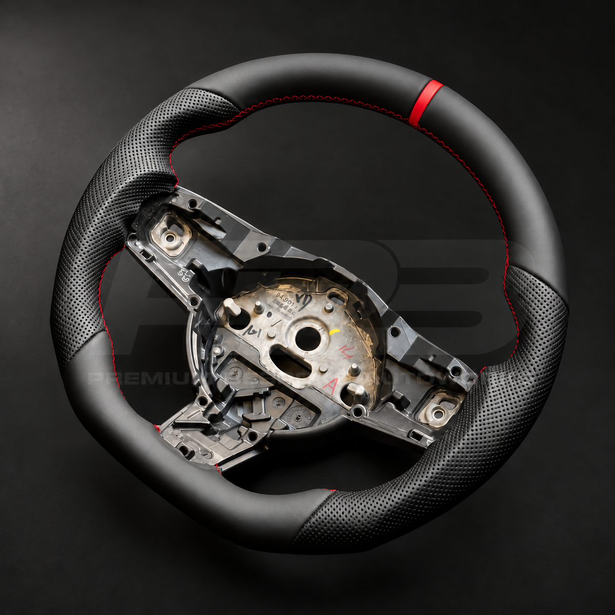 Jaguar F-Type custom steering wheel right angle showing flat bottom, perforated leather grip and red stitching